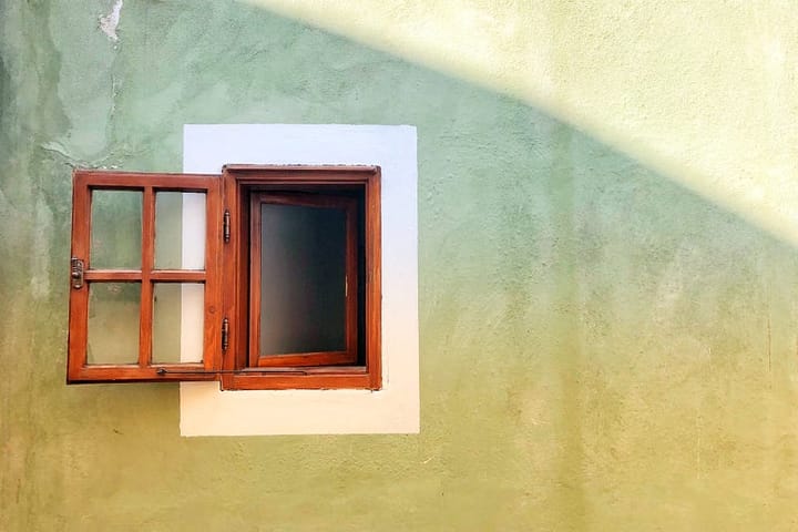 A wood framed window is open