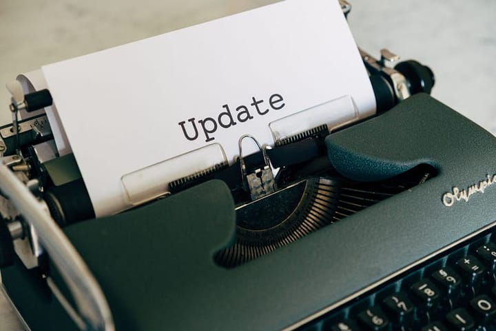 an antique typewriter with a paper inside it saying “update”