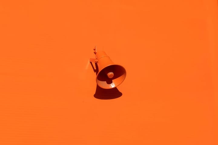 an orange megaphone on an orange background